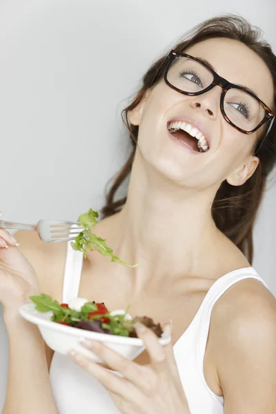 Woman eating fresh salad Royalty Free Stock Images