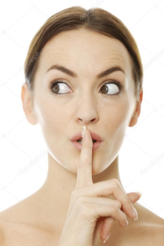 Woman holding her finger over her lips