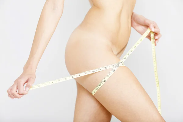 Woman using measuring tape — Stock Photo, Image