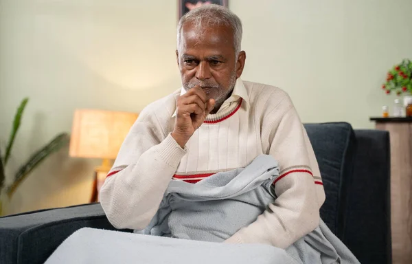 Sick old man woke up in the middle of night while sleeping due to fever and cough. — Stockfoto