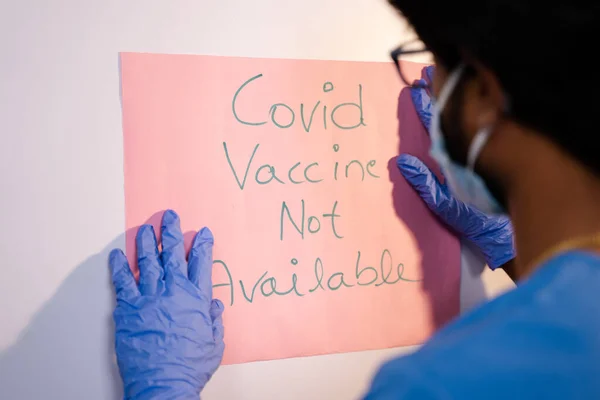 Doctor Pasting Covid Vaccine Available Notice Door Front — Stock Photo, Image