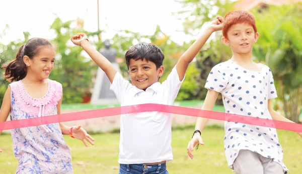 Young child won running case by reaching first - concept of competition, healthy and achieving goals in childhood — Stock Photo, Image