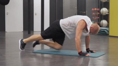 Azimli bir gencin spor salonunda antrenman yaparken bağırışları yavaş çekim. Kas egzersizi yapan bir liman çalışanı, spor salonunda egzersiz yapan bir sporcu..