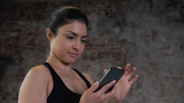 Indian Young Woman Using Smart Phone Surf Internet Gym Workout — Stock Video