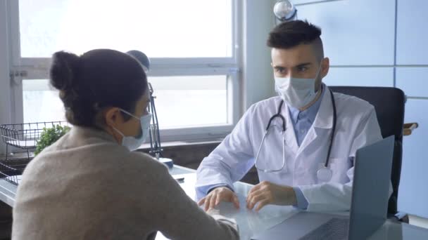 Young European Male Doctor Mask Talks Patient Indian Girl Her — Stock Video