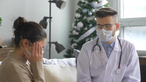 Young Indian Woman Wearing Virus Mask Sitting Sofa Headache Doctor — Stock Video