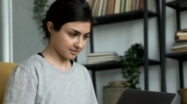 Close-Up Portrait of A Young Indian Woman Working on a Laptop, Doing Online Training or Business, Doing Work At Home in A Cozy Room