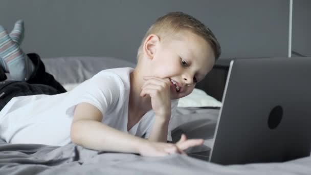 Child Engaged Using Laptop Playing Games Computer Boy Lying Bed — Stock video