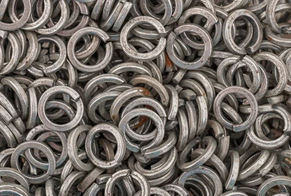 Steel grover washers for industrial manufacturing. Texture background of grover washers. Hight resolution macro photo. No depth of field.