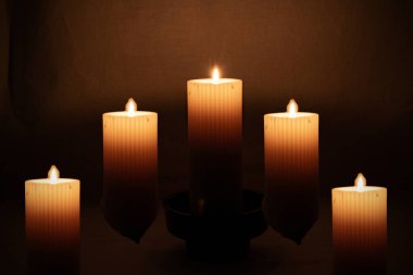 five decorative Halloween candles on a dark background