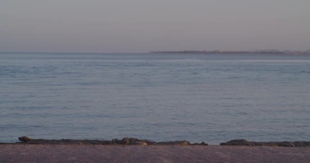 Tıbbi maskeli ve şapkalı yorgun turist Kızıl Deniz 'in yanından geçiyor.. — Stok video