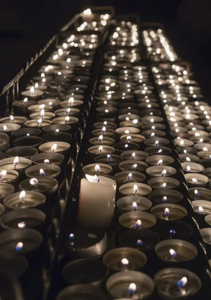 Rows of burning candles inside a church — Stock Photo, Image