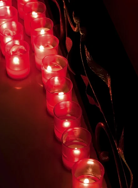 Rows of burning candles inside a church — Stock Photo, Image