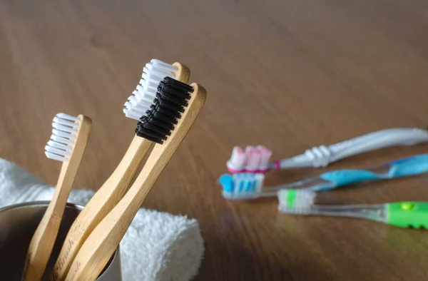 Three Bamboo Toothbrushes Three Plastic Toothbrushes — Stock Photo, Image