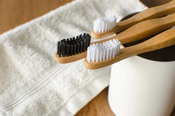 Three Bamboo Family Toothbrushes White Towel Wooden Back — Stock Photo, Image