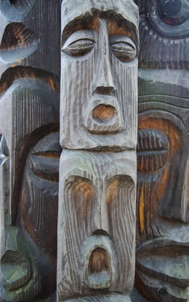 Face carved in wood. sculpture made of wood. Wooden Tree Sculptu