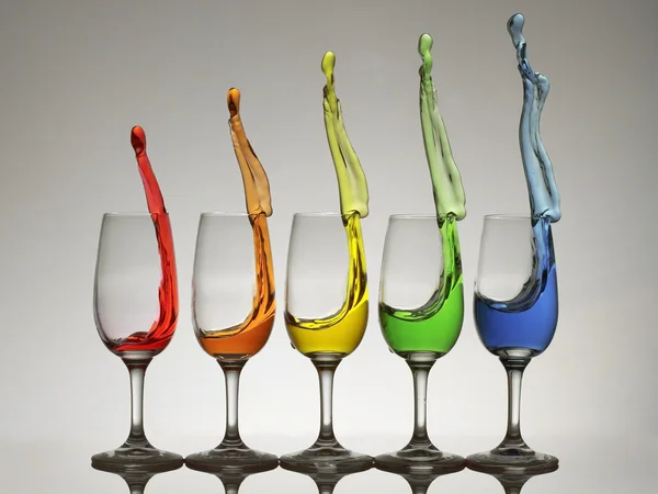 Cheers x5 with colorful splashes from wine glasses — Stock Photo, Image