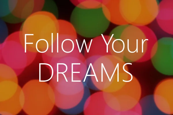 Segui i tuoi sogni testo su sfondo colorato bokeh — Foto Stock