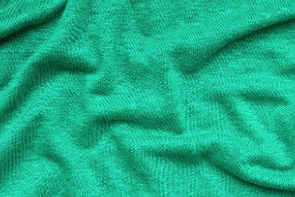 Yeşil dalgalı kumaş arka plan — Stok fotoğraf