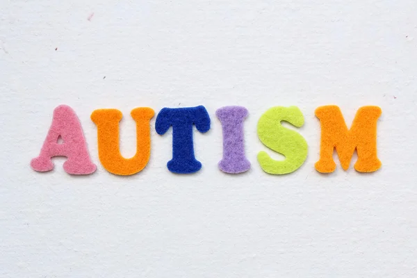 Palabra autismo en textura de papel blanco hecho a mano — Foto de Stock