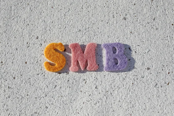 SMB (Small Medium-sized Business) acronym on handmade paper texture — Stock Photo, Image