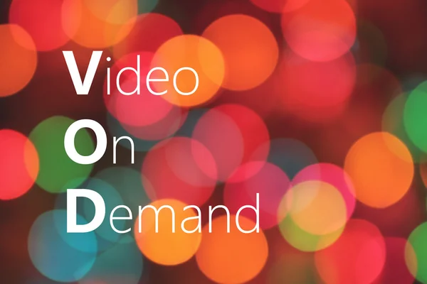 VOD (Video On Demand) acrônimo sobre fundo bokeh colorido — Fotografia de Stock