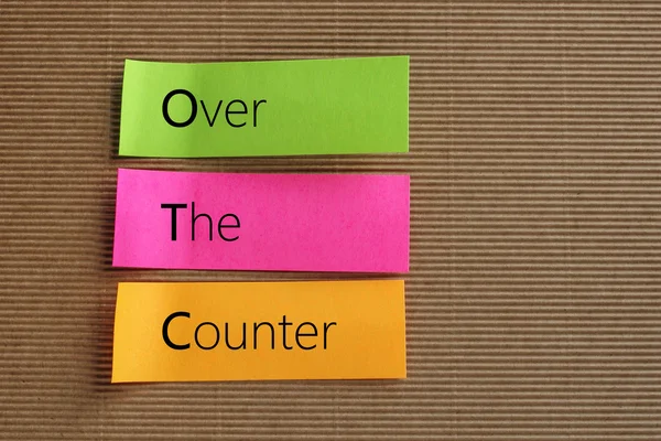 OTC (Over The Counter) acrônimo em notas coloridas pegajosas — Fotografia de Stock