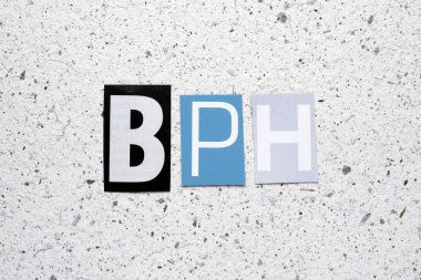 BPH (Benign Prostatic Hyperplasia) acronym cut from newspaper on white handmade paper texture clipart