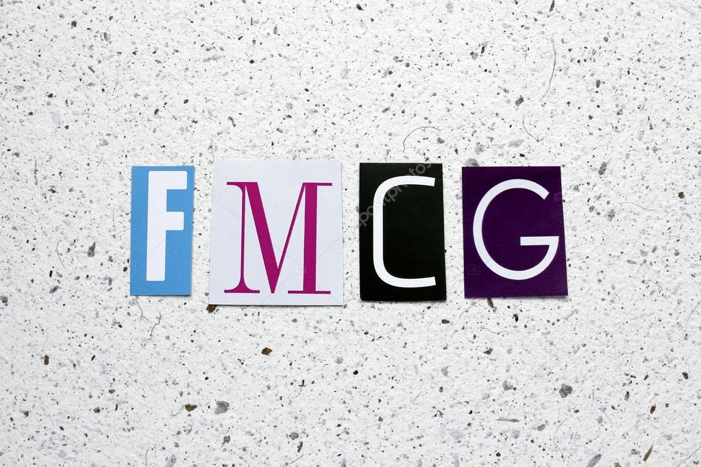 FMCG (Fast Moving Consumer Goods) acronym cut from newspaper on white handmade paper texture