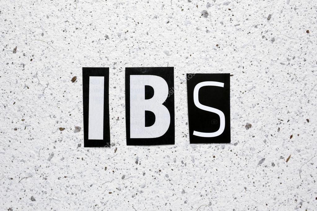 IBS (Irritable Bowel Syndrome) acronym cut from newspaper on white handmade paper texture