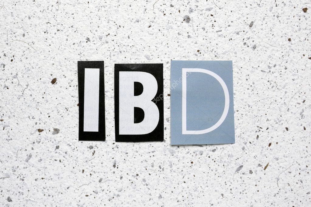 IBD (Inflammatory Bowel Disease) acronym cut from newspaper on white handmade paper texture