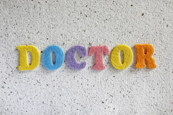 Doctor word on white handmade paper texture — Stock Photo, Image