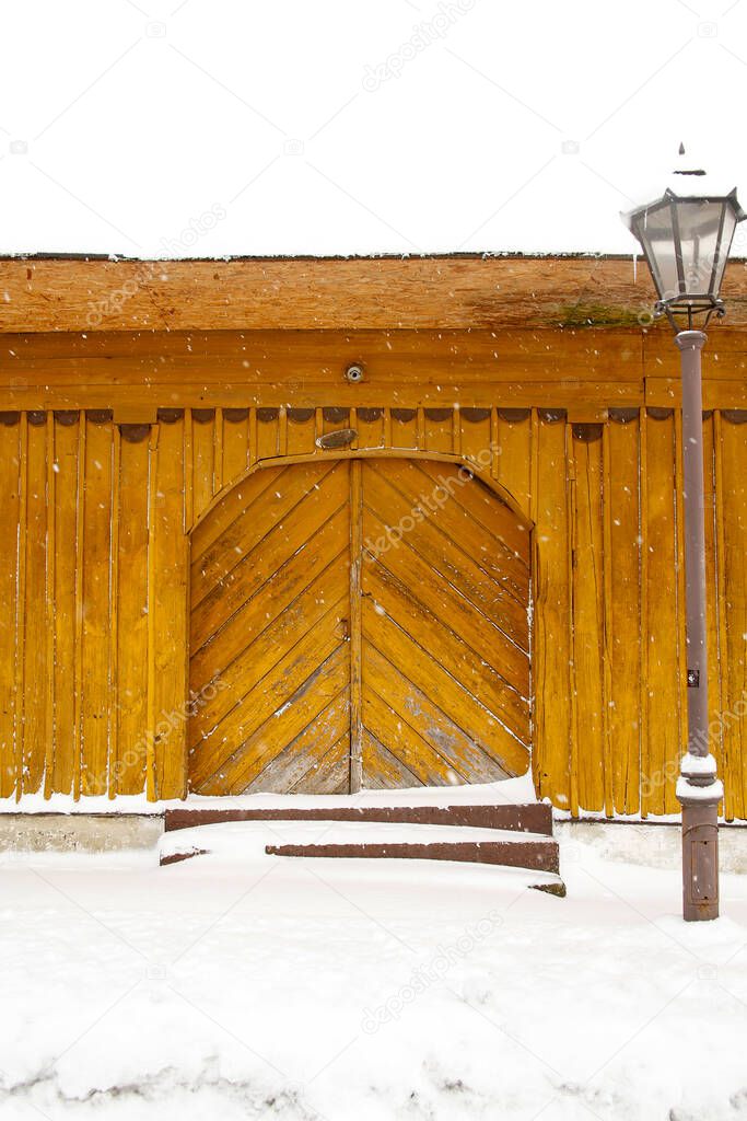 door of a wooden traditional house during snowstorm
