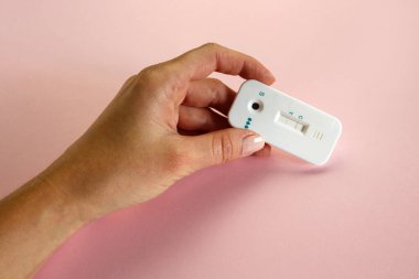 Pembe arka planda kadın eli tutuşu tıbbi benlik testi 