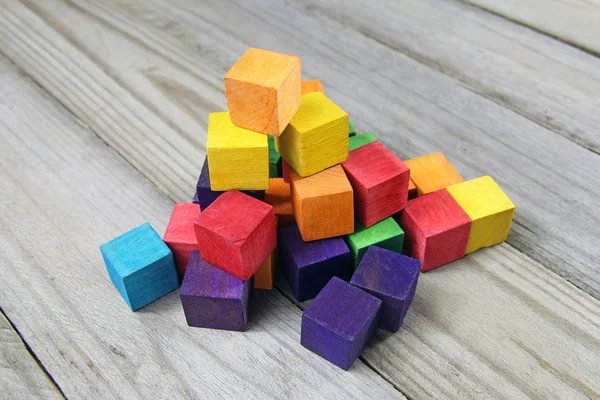 Colorful wooden cubes on wood background — Stock Photo, Image