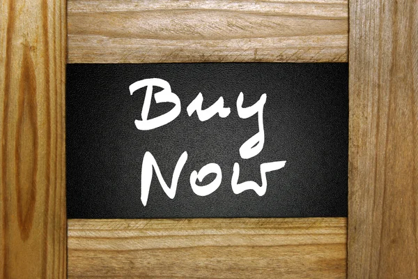 Buy now sign on blackboard in wooden frame — Stock Photo, Image