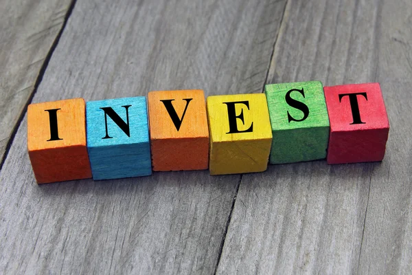 Concept of invest word on wooden colorful cubes — Stock Photo, Image