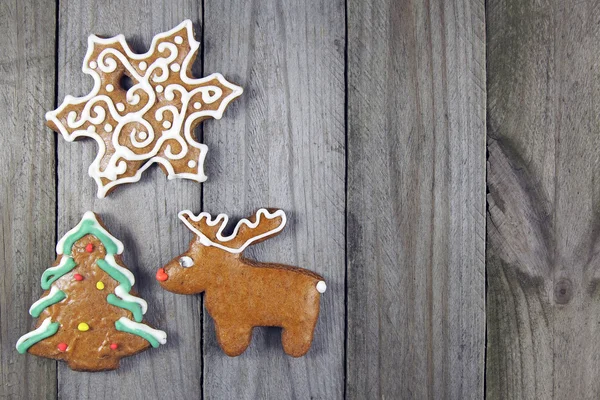 Christmas homemade gingerbread- christmas tree, snowflake and reindeer on wooden background — Stock Photo, Image