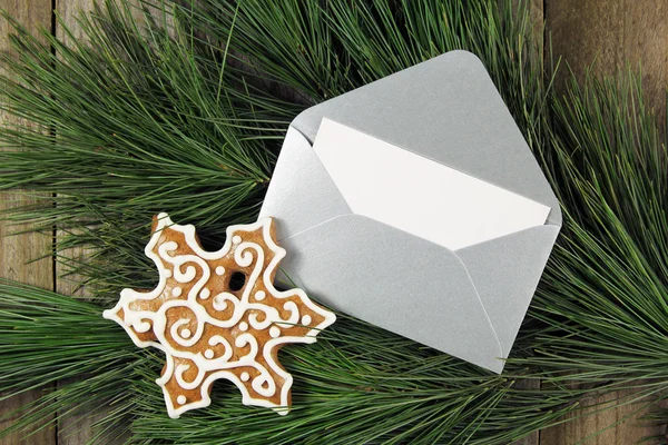 Silver envelope with gingerbread on christmas fir tree — Stock Photo, Image