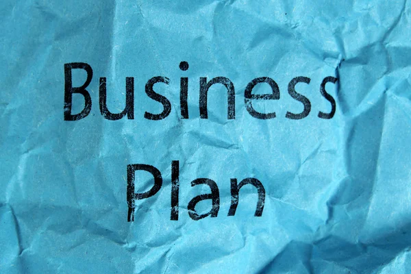 Texto del plan de negocio sobre papel azul — Foto de Stock