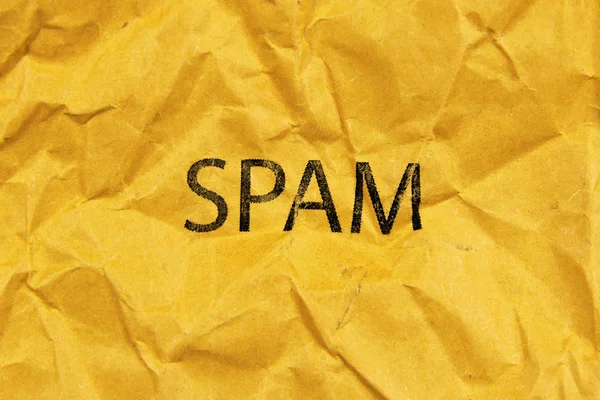 Word spam on yellow paper — Stock Photo, Image