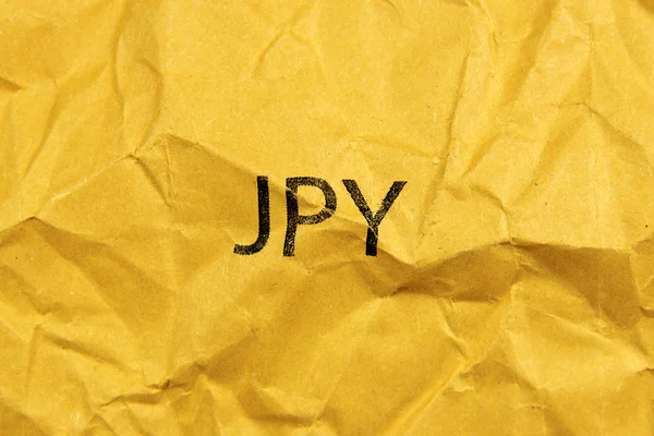 Simbolo dello yen giapponese JPY su carta gialla — Foto Stock
