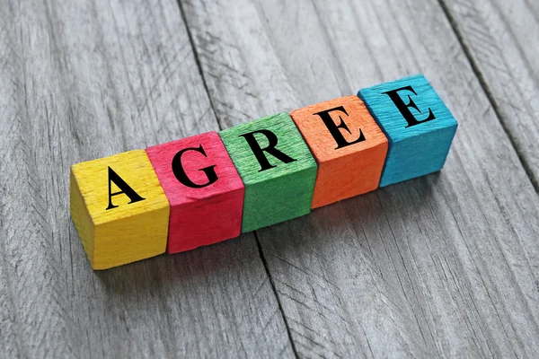 Word agree on colorful wooden cubes — Stock Photo, Image