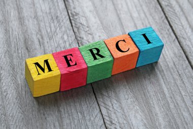 word merci (thank you in french) on colorful wooden cubes