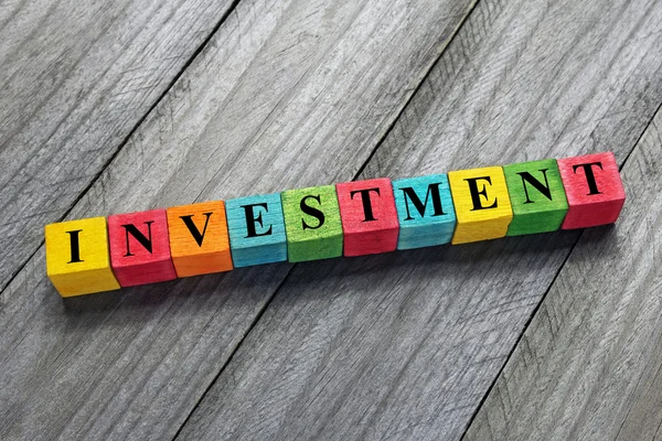 Investment word on colorful wooden cubes — Stock Photo, Image