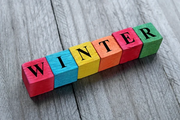 Winter text on colorful wooden cubes — ストック写真