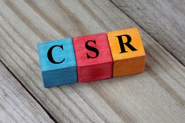 CSR text (Corporate Social Responsibility) on colorful wooden cu
