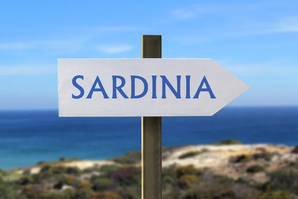 Sardinia sign with seashore in the background — Stock Photo, Image