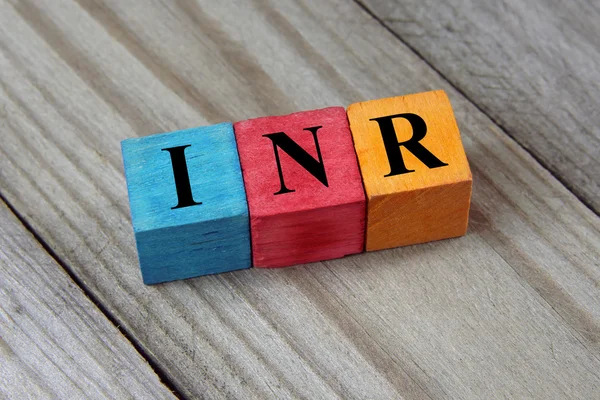 INR (Indian Rupee) sign on colorful wooden cubes — Stock Photo, Image