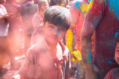 Jodhpur, Rajastha, Hindistan - 20 Mart 2020: Holi festivalini kutlayan şirin küçük Hintli çocuk portresi, renkli pudrayla kaplanmış yüz resmi.
